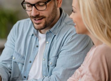 happy-man-his-wife-using-digital-tablet-while-being-meeting-with-bank-manager-office happy-man-his-wife-using-digital-tablet-while-being-meeting-with-bank-manager-office